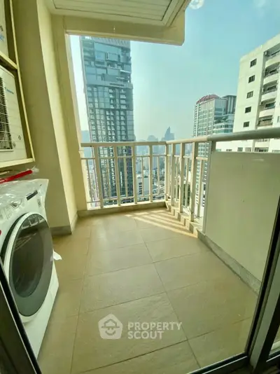 Spacious balcony with city view and washing machine, perfect for urban living.