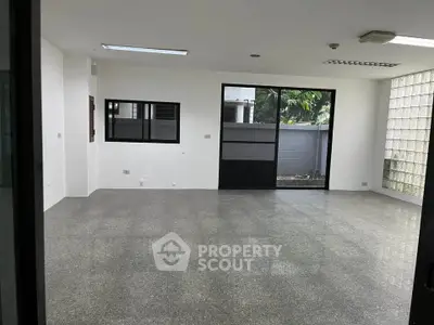 Spacious empty room with large windows and modern flooring, ideal for customization.