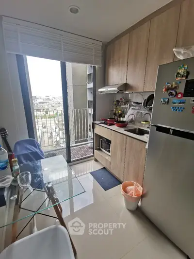 Modern kitchen with glass dining table and balcony view in urban apartment