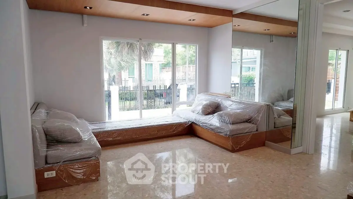 Spacious living room with large windows and modern decor