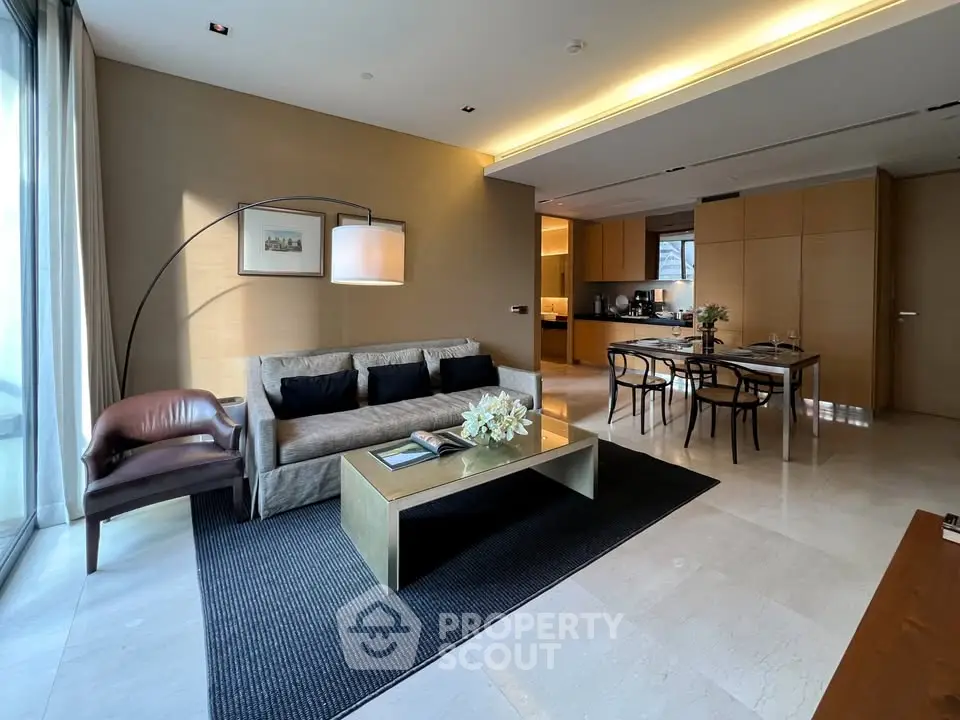 Luxurious open-plan living room with modern furnishings and elegant dining area