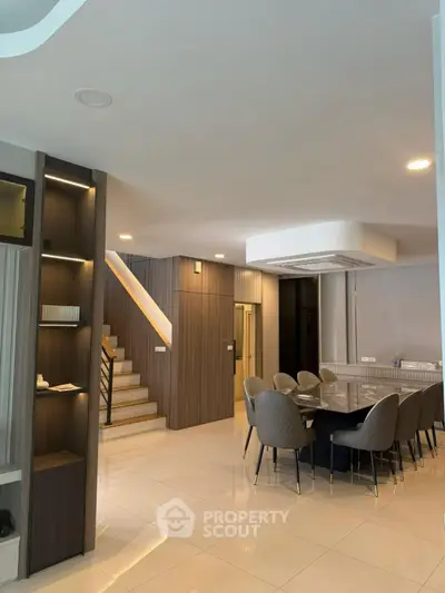 Modern dining area with elegant staircase and stylish decor