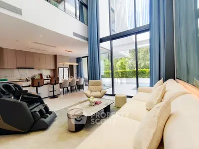Luxurious modern living room with high ceilings and large windows overlooking a lush garden.
