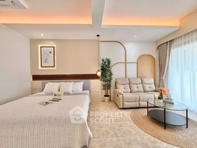 Modern bedroom with cozy seating area and stylish decor