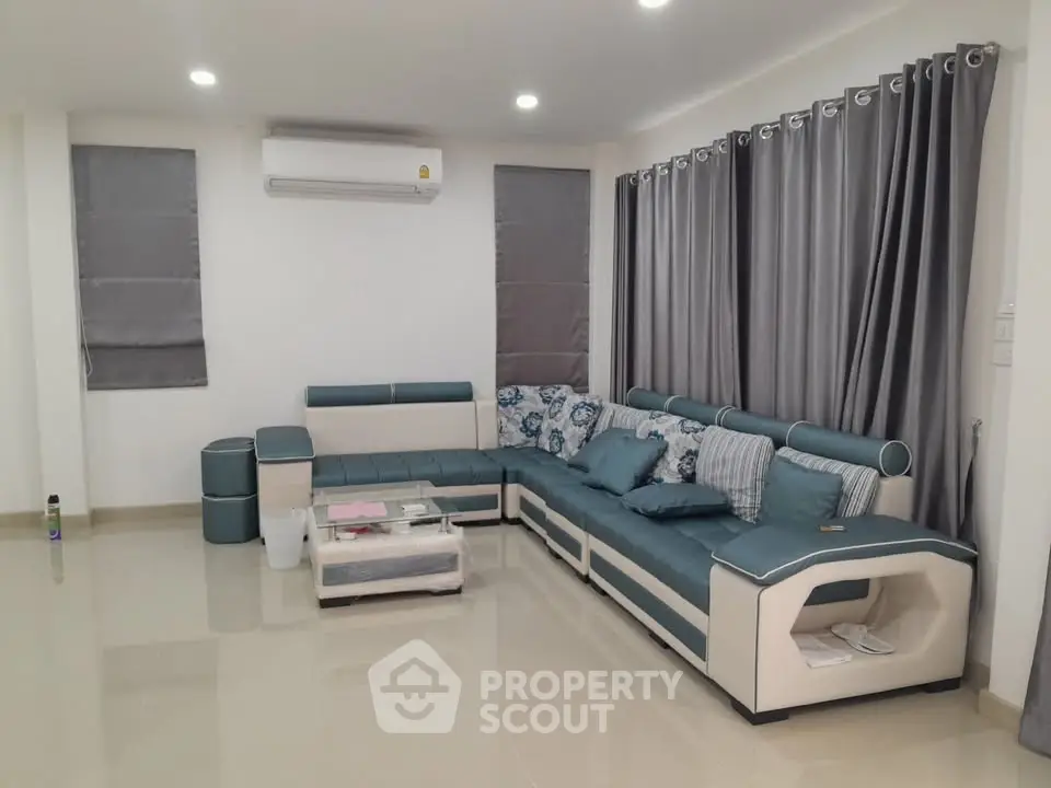 Modern living room with stylish sectional sofa and elegant curtains