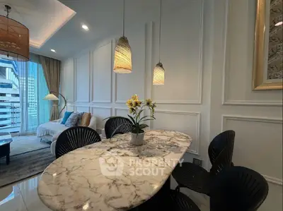 Luxurious living room with elegant marble table and modern decor in high-rise apartment.