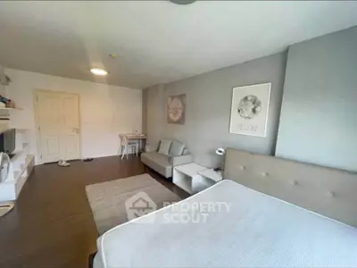 Spacious bedroom with modern decor and cozy seating area