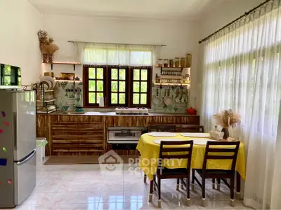 Charming kitchen with rustic decor and natural light, featuring a cozy dining area and modern appliances.