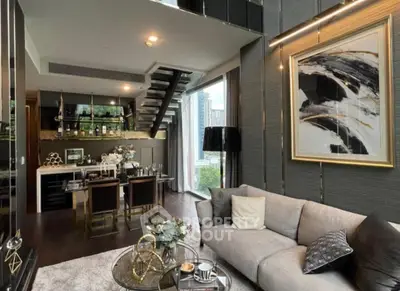 Luxurious modern living room with open kitchen and stylish decor in high-rise apartment.