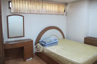 Cozy bedroom with wooden furniture and natural light