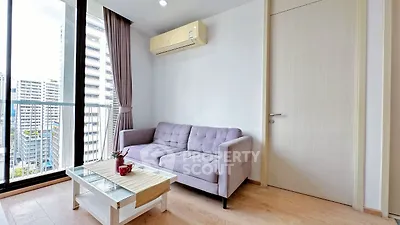 Modern living room with city view, featuring a cozy sofa and stylish coffee table.