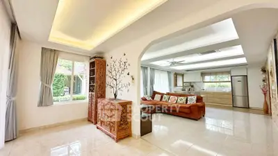 Spacious open-plan living room with elegant decor and garden view