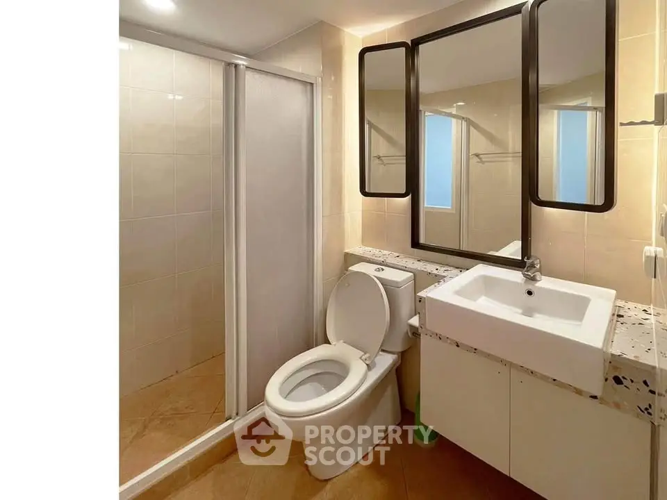 Modern bathroom with sleek fixtures and spacious shower in contemporary home.
