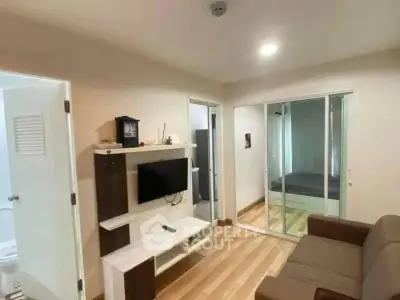 Modern living room with sleek design and cozy atmosphere, featuring a wall-mounted TV and stylish furniture.