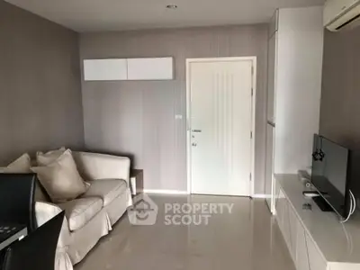 Modern living room with sleek furniture and neutral tones, perfect for relaxation and entertainment.