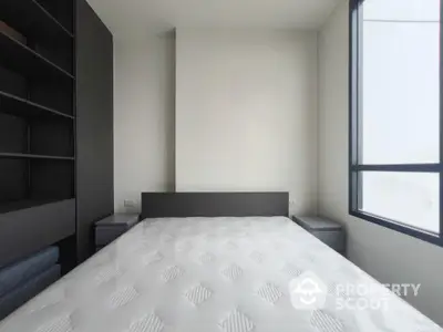 Modern minimalist bedroom with large window and built-in shelving