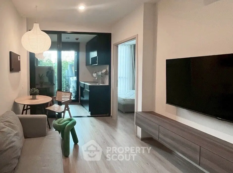 Modern living room with sleek furniture and open kitchen layout