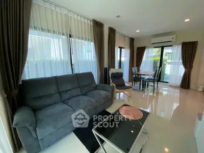 Spacious living room with modern furniture and large windows for natural light