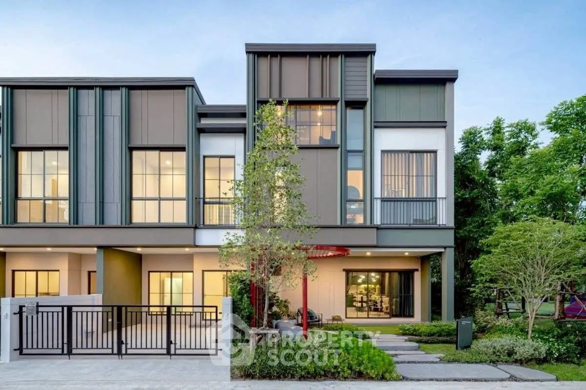 Modern townhouse exterior with sleek design and lush landscaping