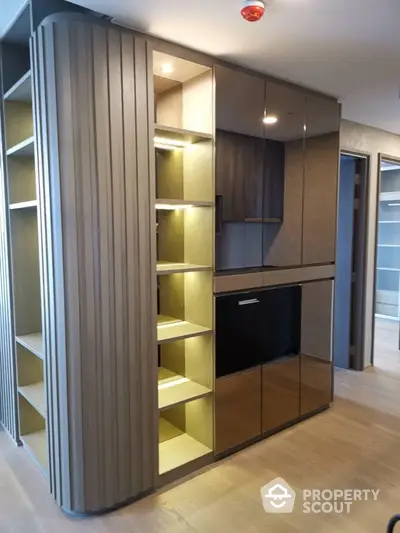 Modern interior with sleek cabinetry and open shelving in a stylish apartment