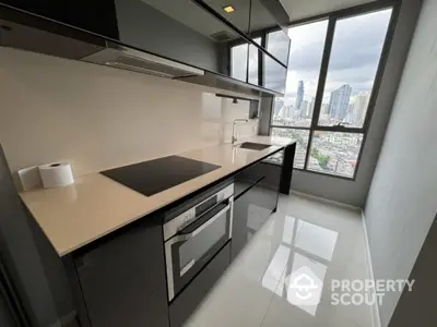 Modern kitchen with sleek black cabinets and city view from large window