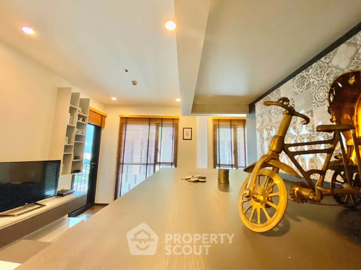 Modern living room with stylish decor and large windows offering natural light.