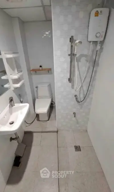 Compact bathroom with modern fixtures and shower in a real estate property.