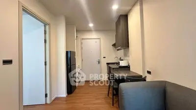 Modern apartment interior with compact kitchen and cozy living area