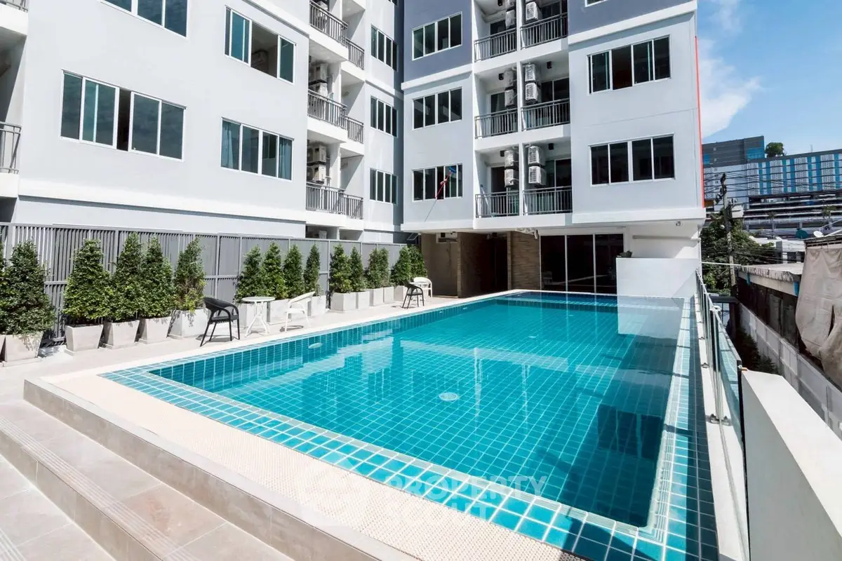 Modern apartment building with a pristine outdoor pool and stylish design.