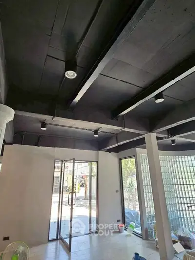 Modern commercial space with glass doors and high ceilings, ideal for retail or office use.