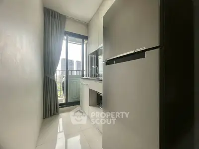Modern kitchen with sleek appliances and city view from window