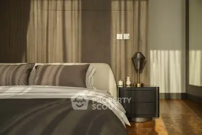 Luxurious bedroom with elegant decor and soft lighting, featuring a stylish bed and modern nightstand.