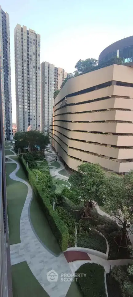 Stunning urban view of modern high-rise buildings with lush landscaped gardens.