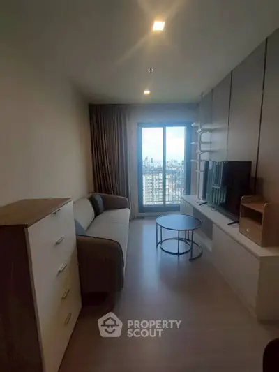 Cozy living room with city view, modern furniture, and natural light