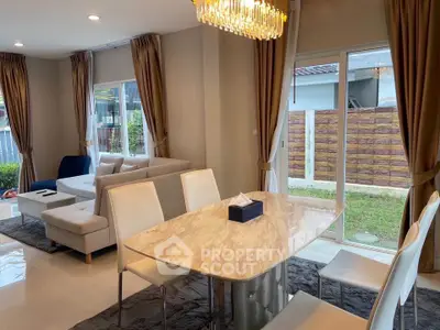 Elegant living room with modern dining area and large windows in a stylish home