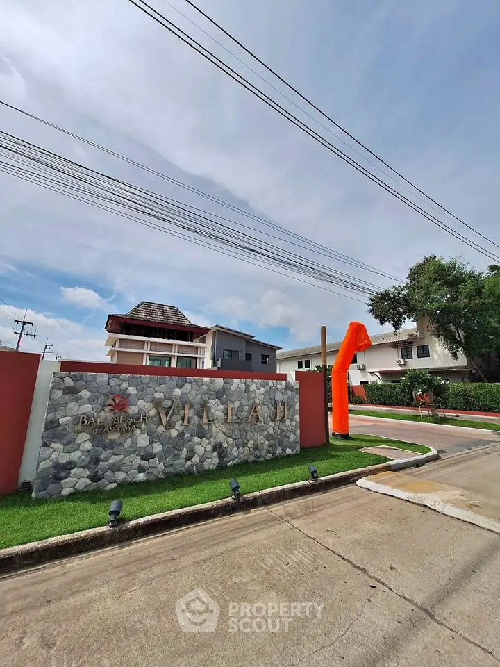 Charming residential villa entrance with modern architecture and lush landscaping.