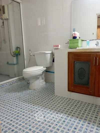 Spacious bathroom with modern fixtures and stylish tile flooring.