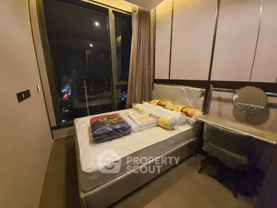 Luxurious bedroom with city view, featuring a plush bed and elegant decor, perfect for urban living.