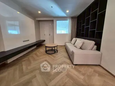 Modern living room with herringbone flooring and sleek furniture design