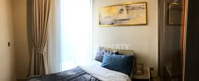 Cozy bedroom with elegant decor and large window for natural light