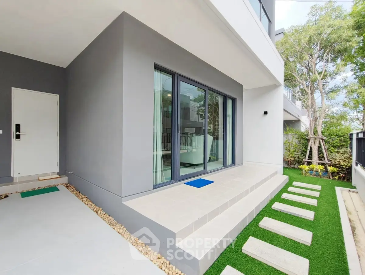 Modern exterior with sleek design and lush garden pathway