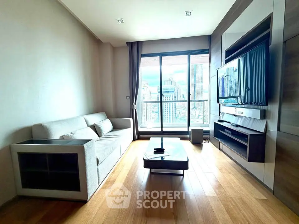 Modern living room with city view, sleek furniture, and wooden flooring in a high-rise apartment.