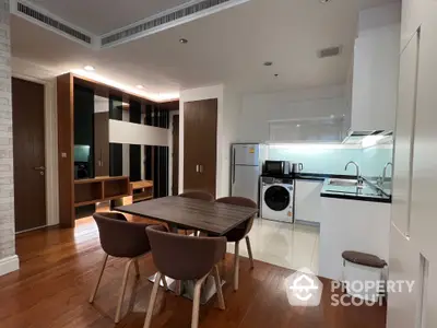 Modern kitchen with dining area and washing machine in stylish apartment