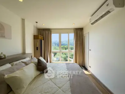 Spacious bedroom with scenic view and modern air conditioning