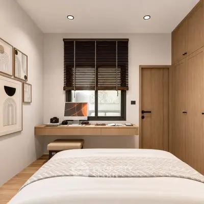 Modern bedroom with stylish decor and workspace, featuring wooden accents and natural light.