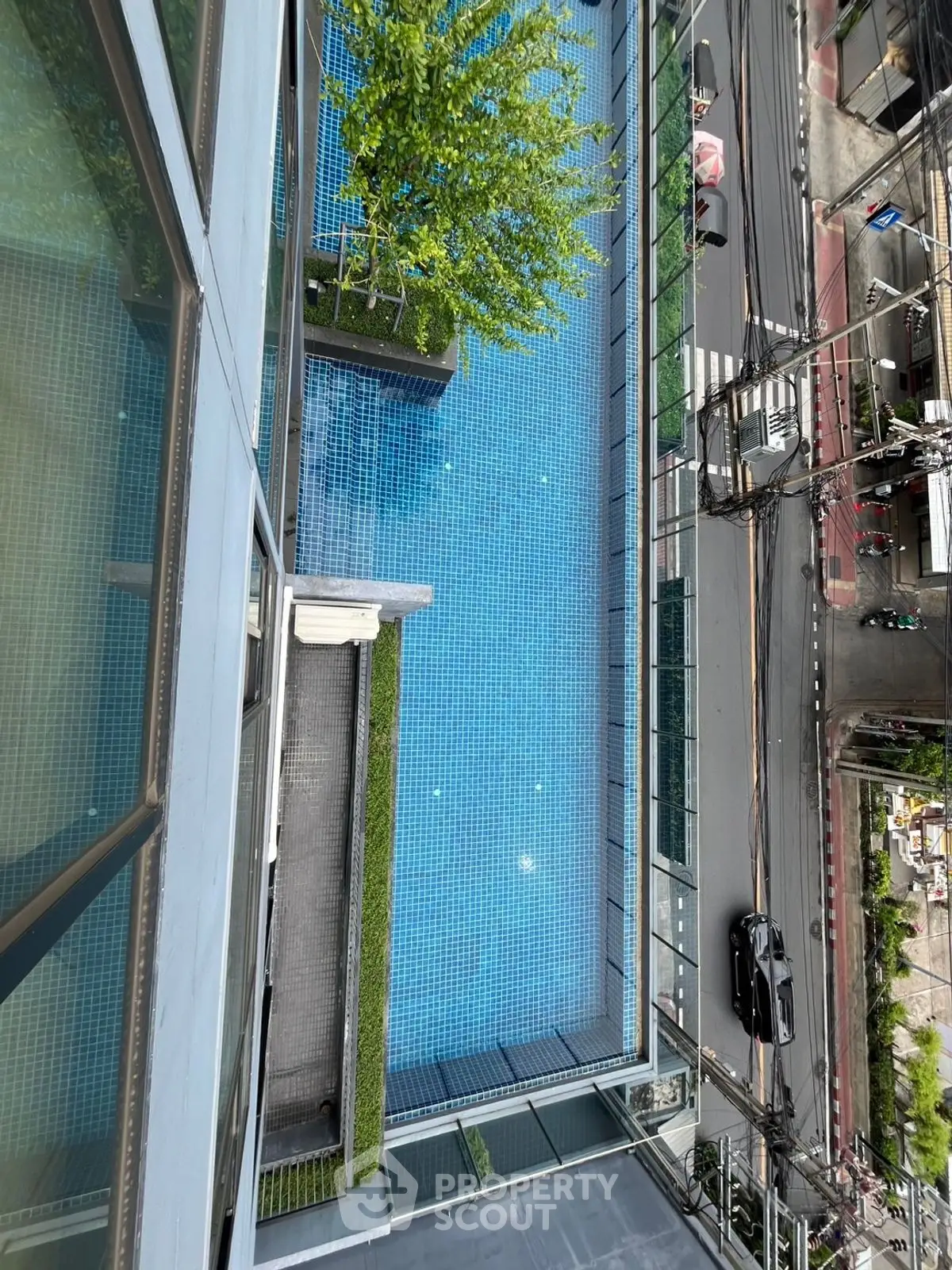 Stunning aerial view of a modern rooftop pool in an urban setting, perfect for relaxation and leisure.