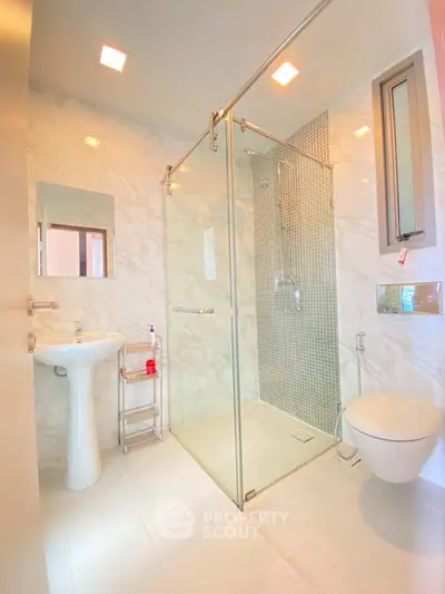 Modern bathroom with glass shower enclosure and elegant fixtures
