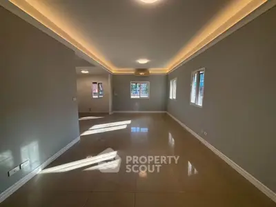 Spacious empty living room with elegant lighting and tiled flooring