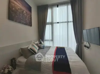 Cozy modern bedroom with large window and stylish decor