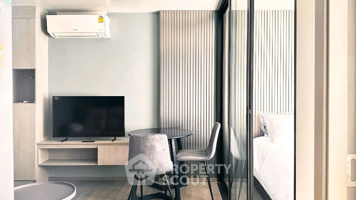 Modern apartment interior with sleek furniture and stylish decor, featuring a cozy living area and bedroom.